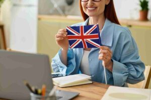 smiling-woman-holding-union-jack-in-kitchen