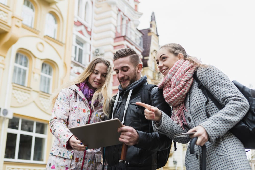 Young people browsing through residency options while exploring the streets of London for settling long-term residency