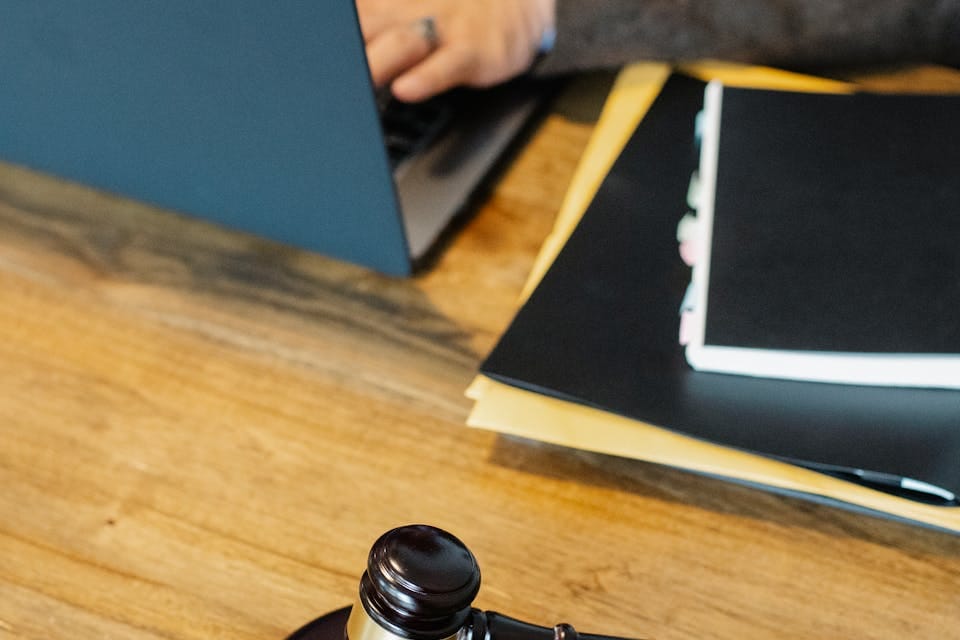 (An image can be seen of a solicitor reviewing a modern judicial review on laptop)
