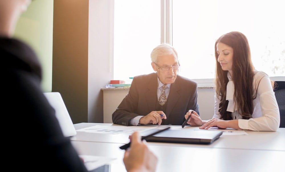(In the image it can be seen a young solicitor guiding an industrialist about importance of directors liability insurance)