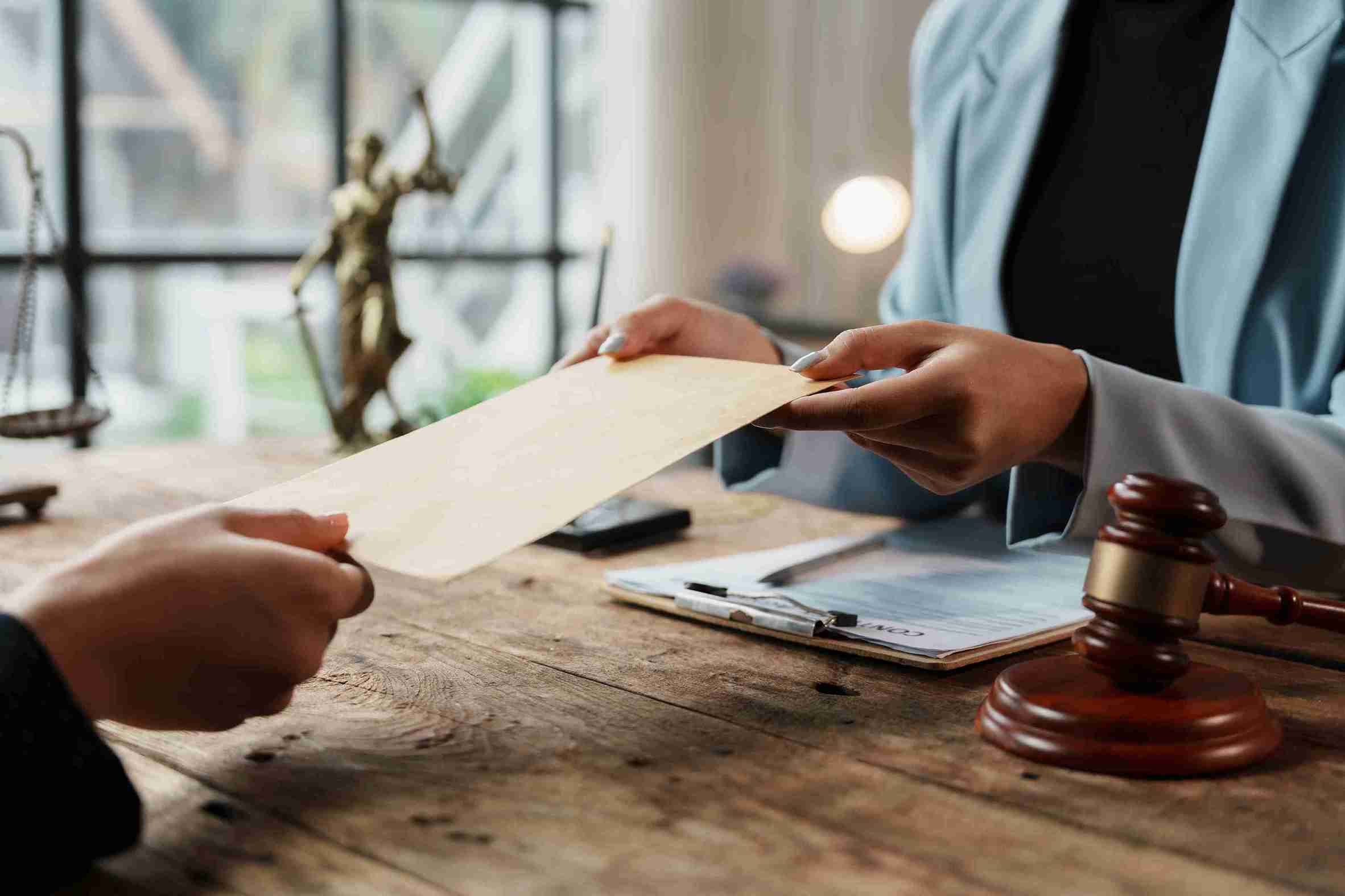 close-up-exchange-of-legal-documents-over-a-wooden