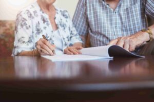 You can see two different people, one working on a will and the other on a living trust document (Living Trust vs Will What are the Key Differences)