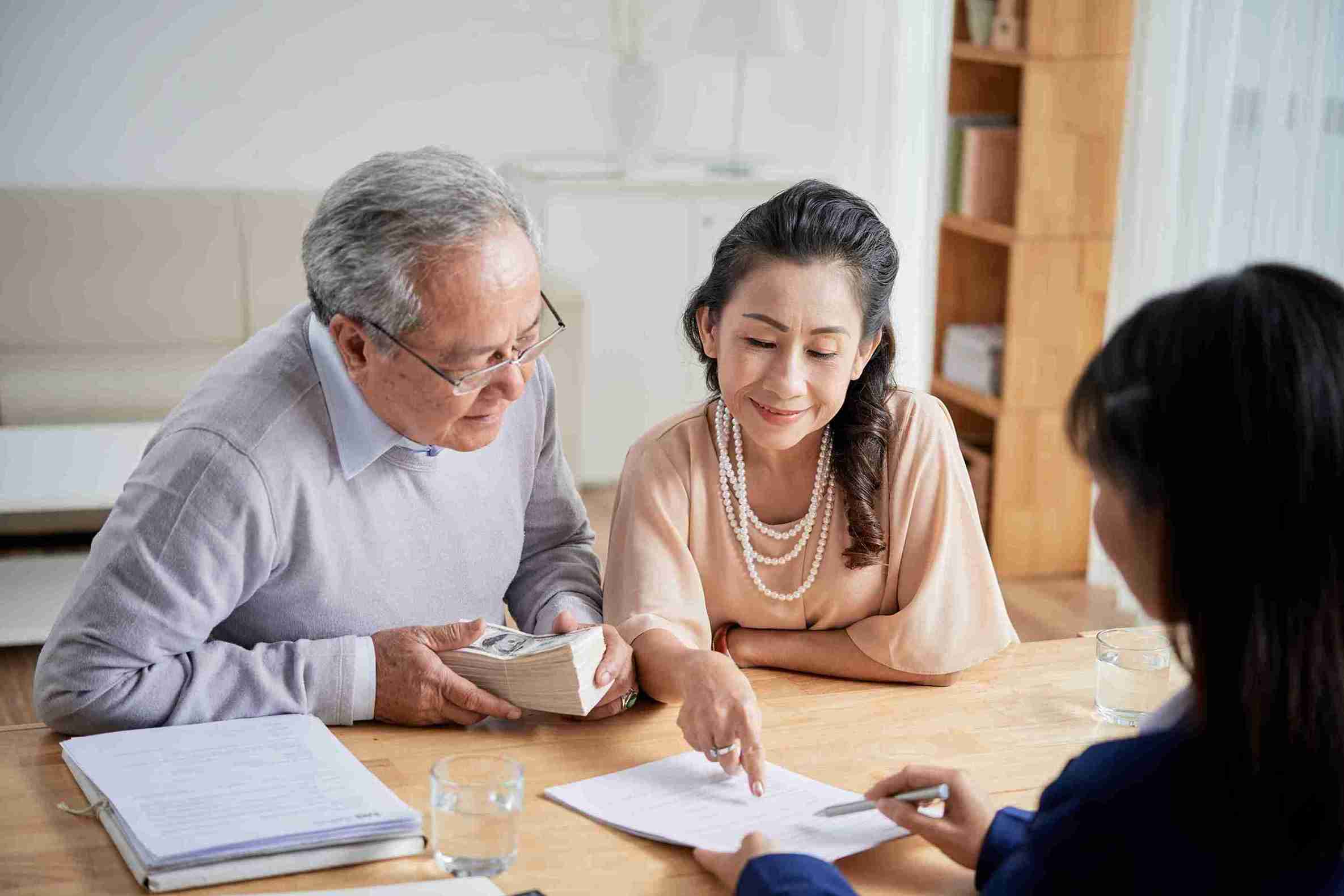senior-couple-reviewing-finances-with-financial-ad