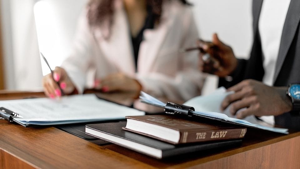 (In the image it can be seen that solicitors discussing key legal principles behind judicial review in immigration law)

