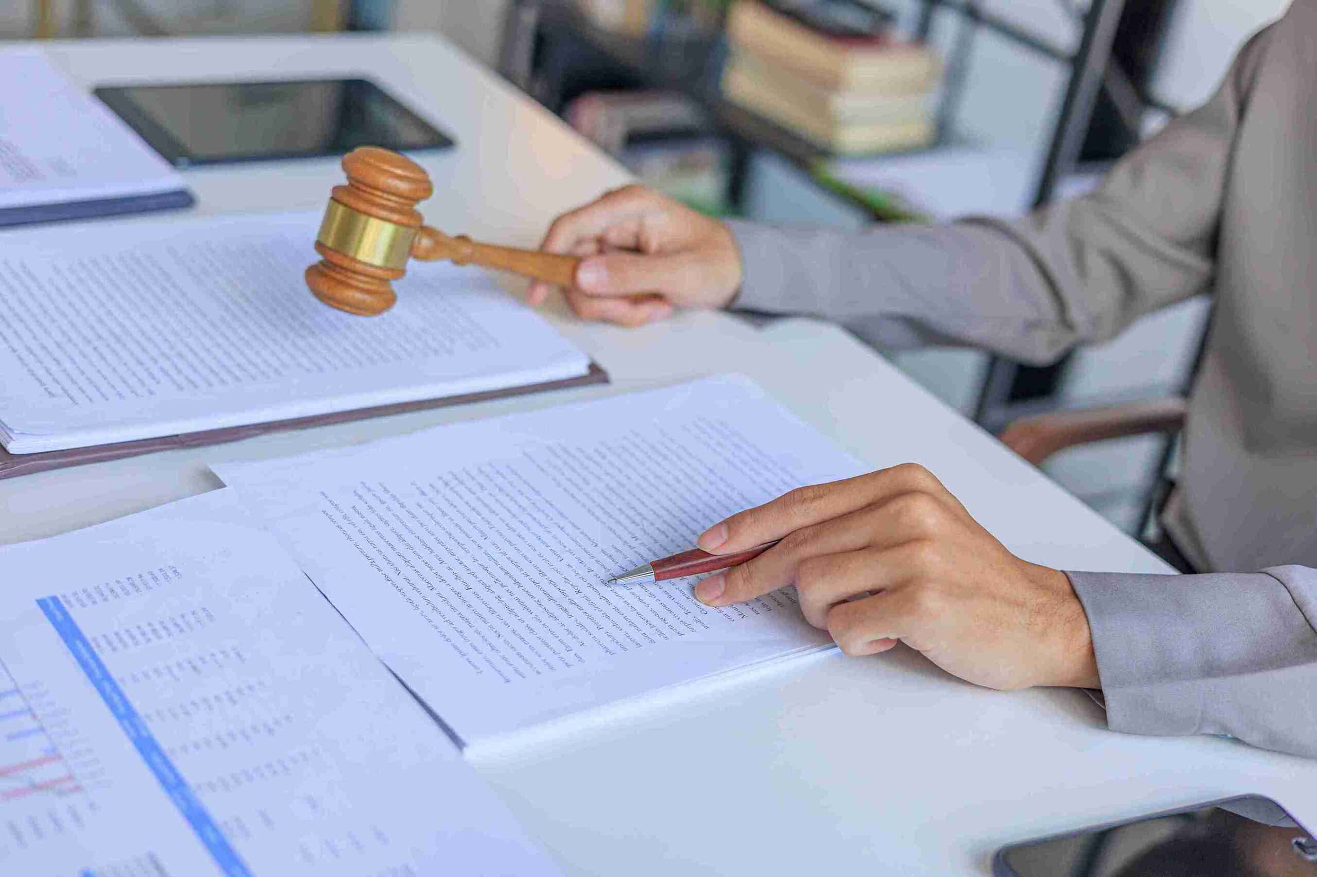 legal-professional-holding-a-wooden-gavel-over-imp