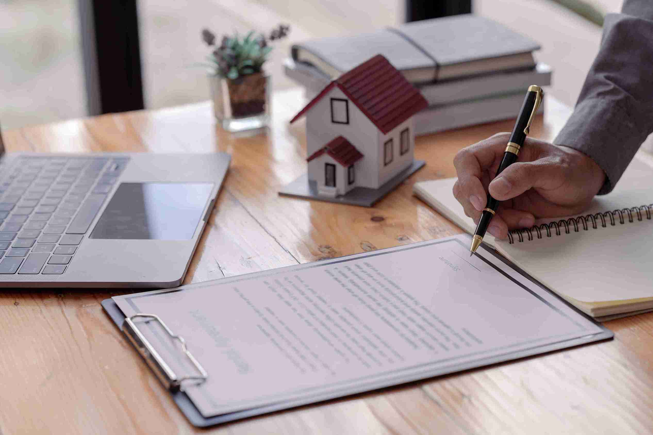 real-estate-contract-being-signed-at-desk