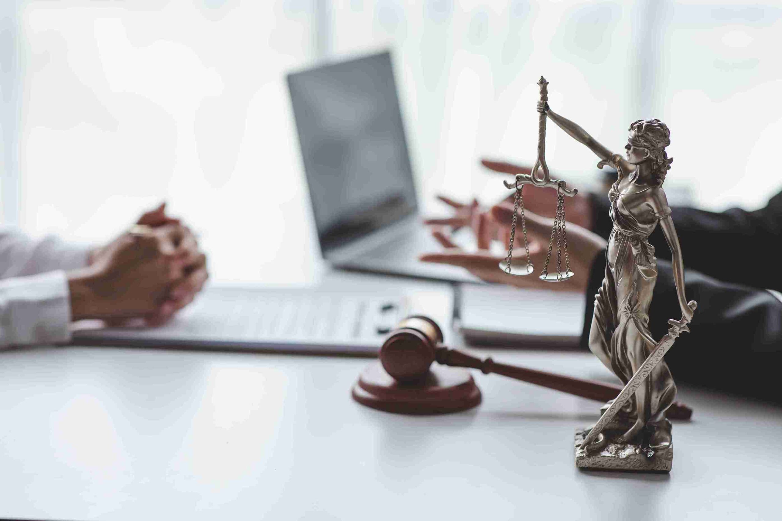 scales-of-justice-statue-with-gavel-and-laptop