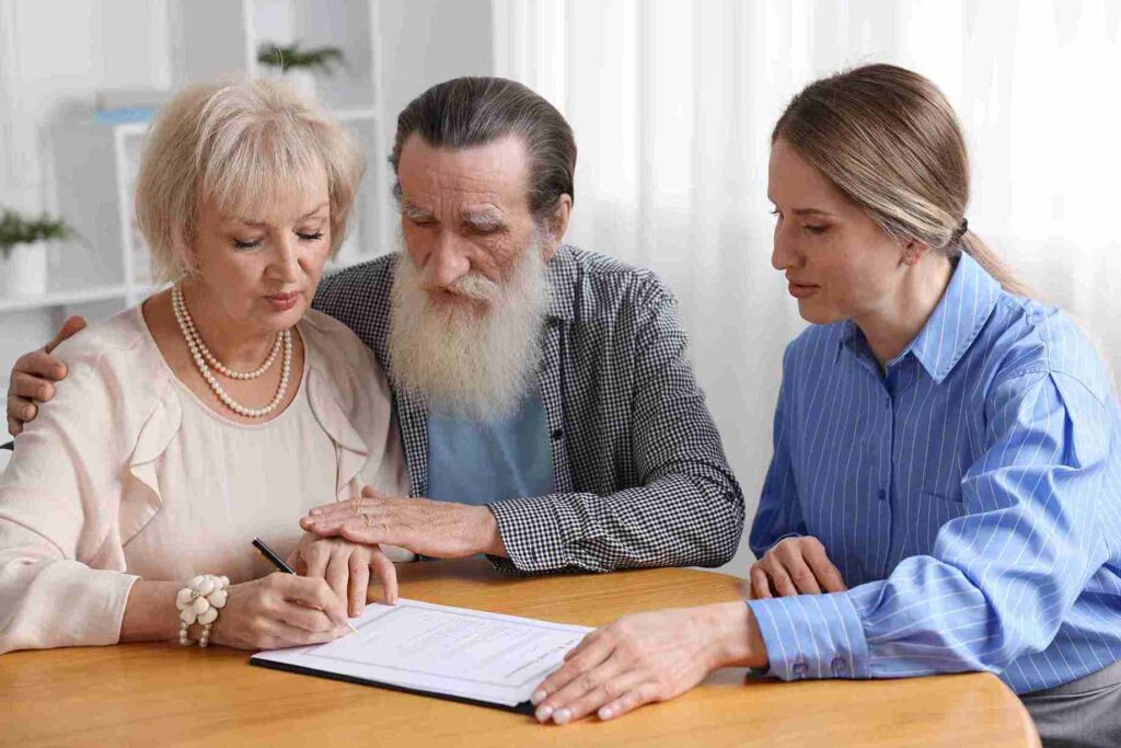 senior-couple-signing-documents-with-advisor-prese