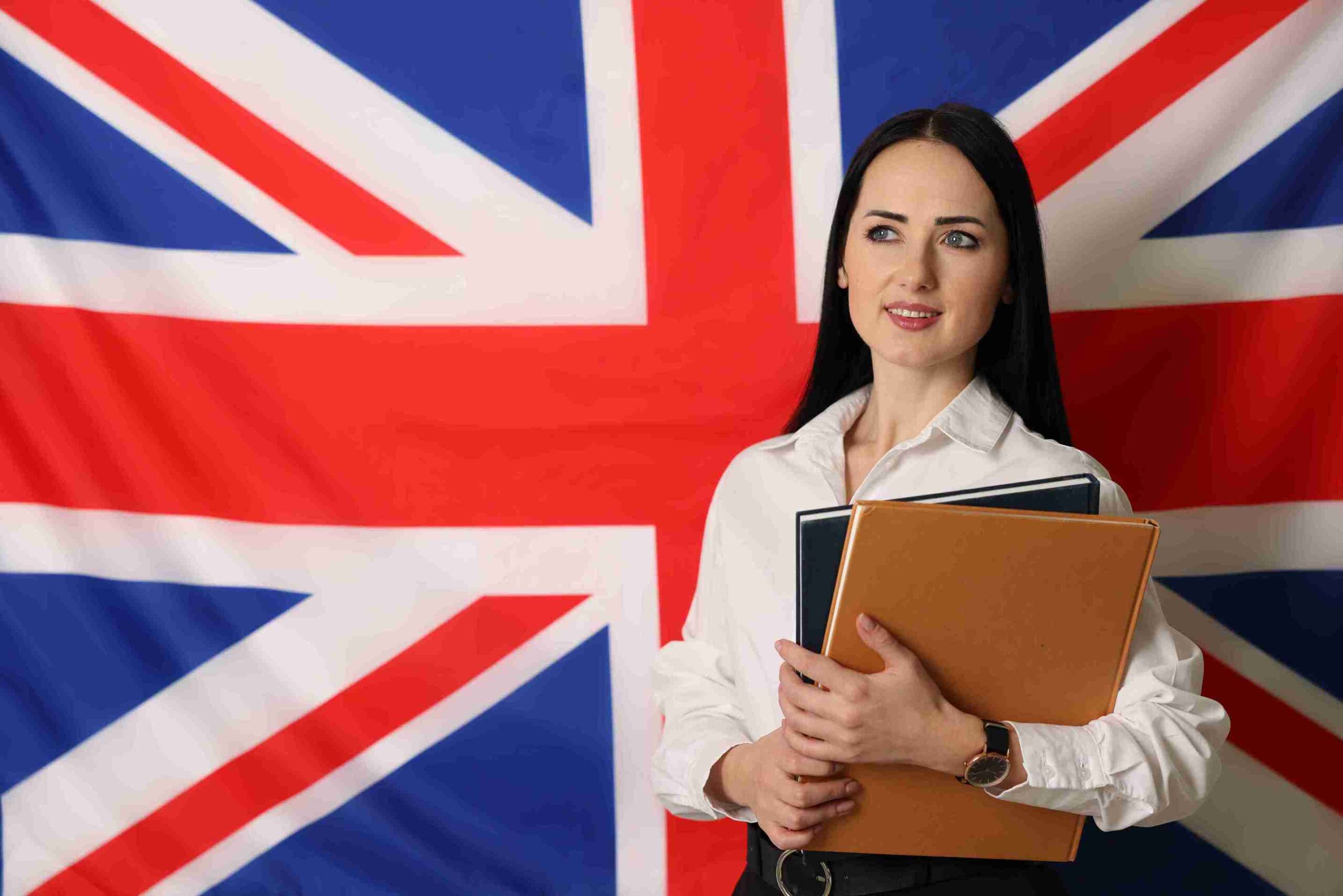woman-holding-books-against-british-flag-backdrop