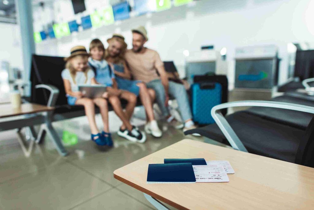family-at-airport-waiting-with-plane-tickets