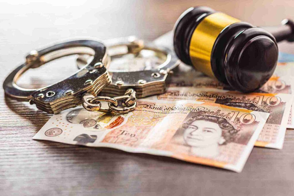 gavel-handcuffs-and-money-on-a-wood-table