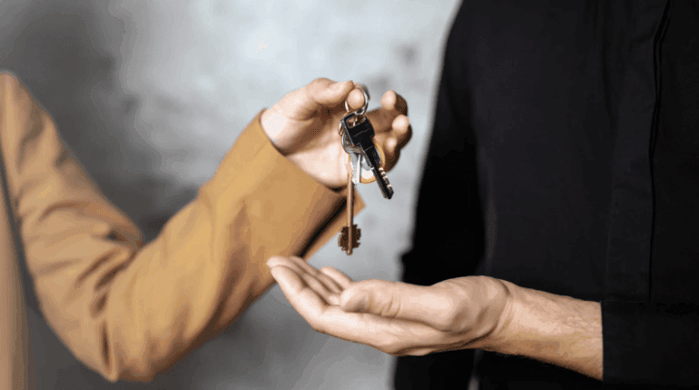 A man hands a key to a woman, symbolizing trust and a new beginning.