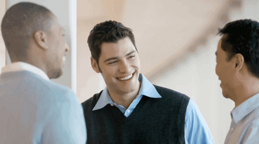 (Three men are smiling and engaged in conversation in a bright office setting)Co-Ownership
