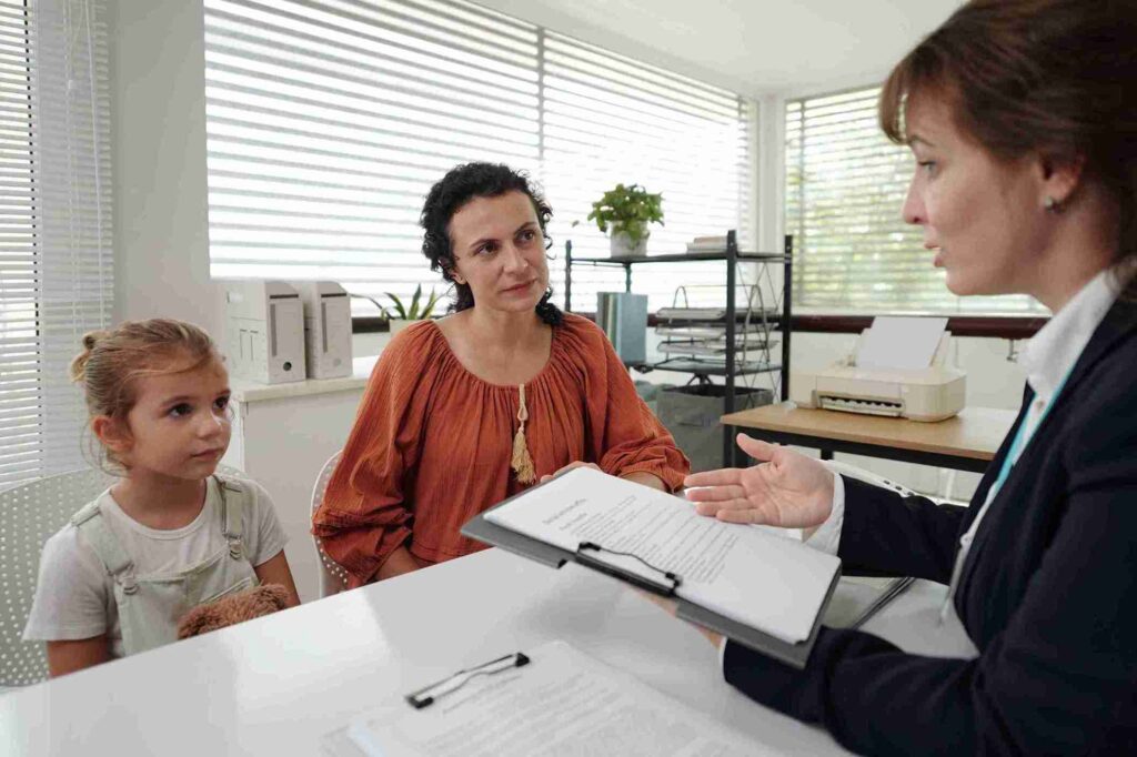 woman-explains-paperwork-to-mother-and-child