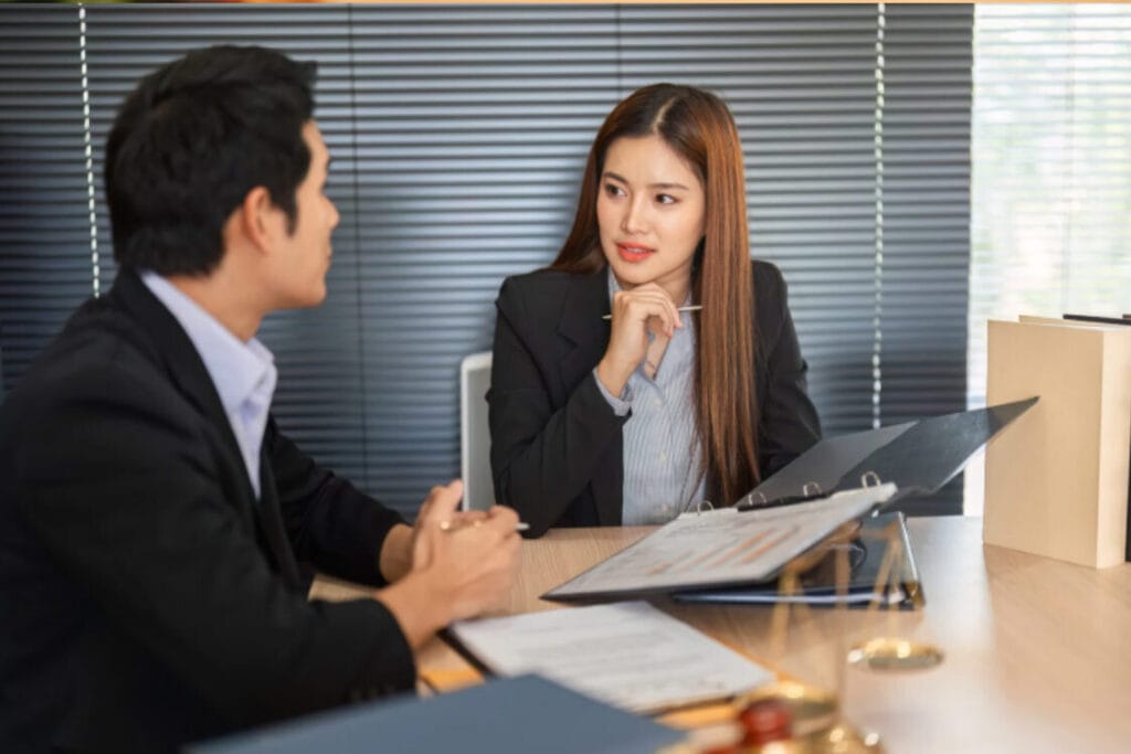 (Professionals discussing ILR documents and strategy.)