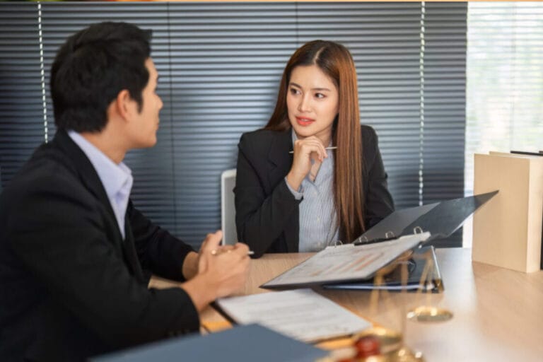 (Professionals discussing ILR documents and strategy.)