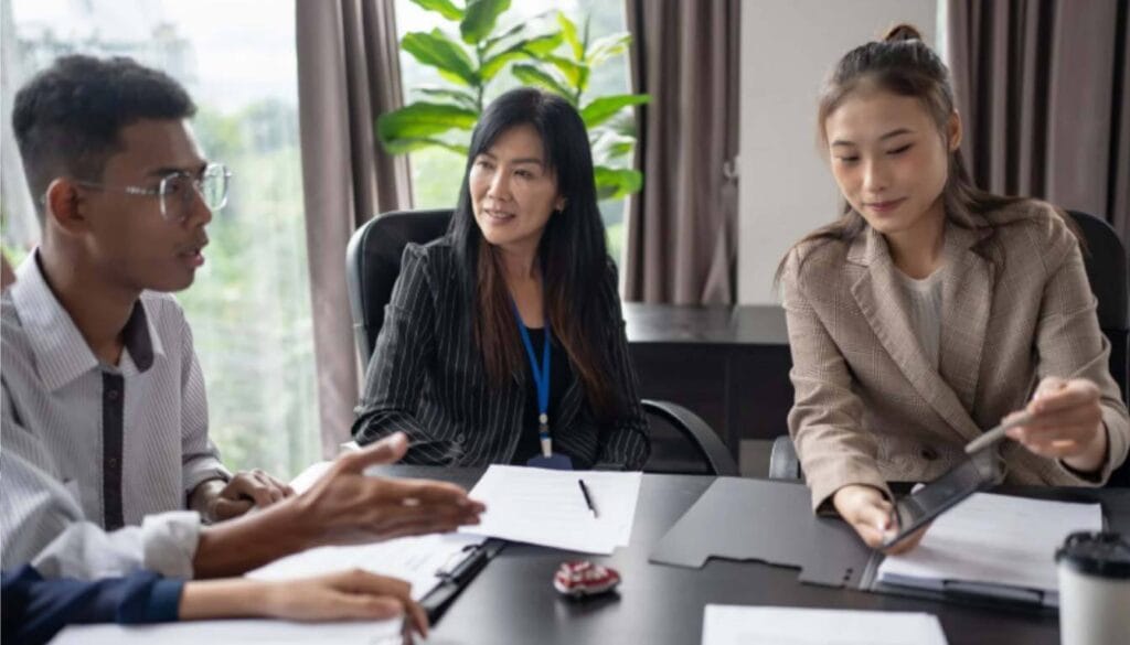 Group of high-net-worth individuals discussing new UK business and investment visa strategies.