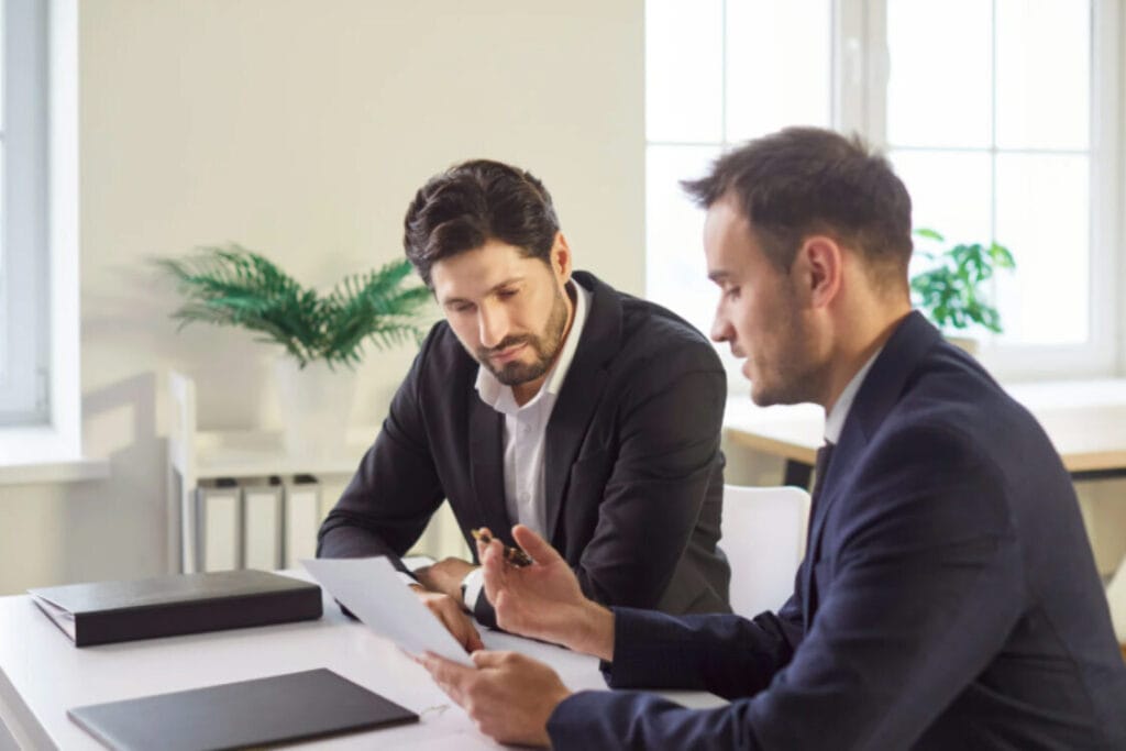 (Two professionals reviewing legal documents related to an unspent conviction or immigration application.)unspent convictions