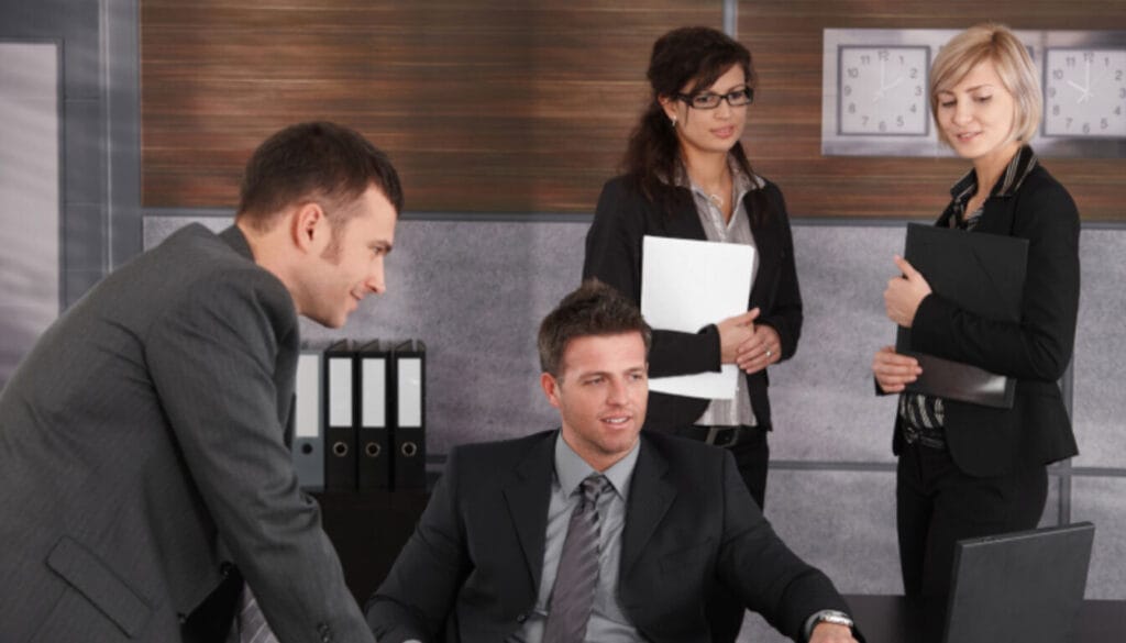 Sponsoring organisation representatives or UK immigration lawyers discussing a religious worker's application.