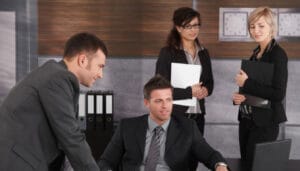Sponsoring organisation representatives or UK immigration lawyers discussing a religious worker's application.