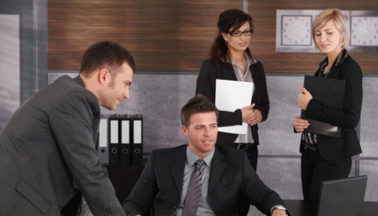 Sponsoring organisation representatives or UK immigration lawyers discussing a religious worker's application.