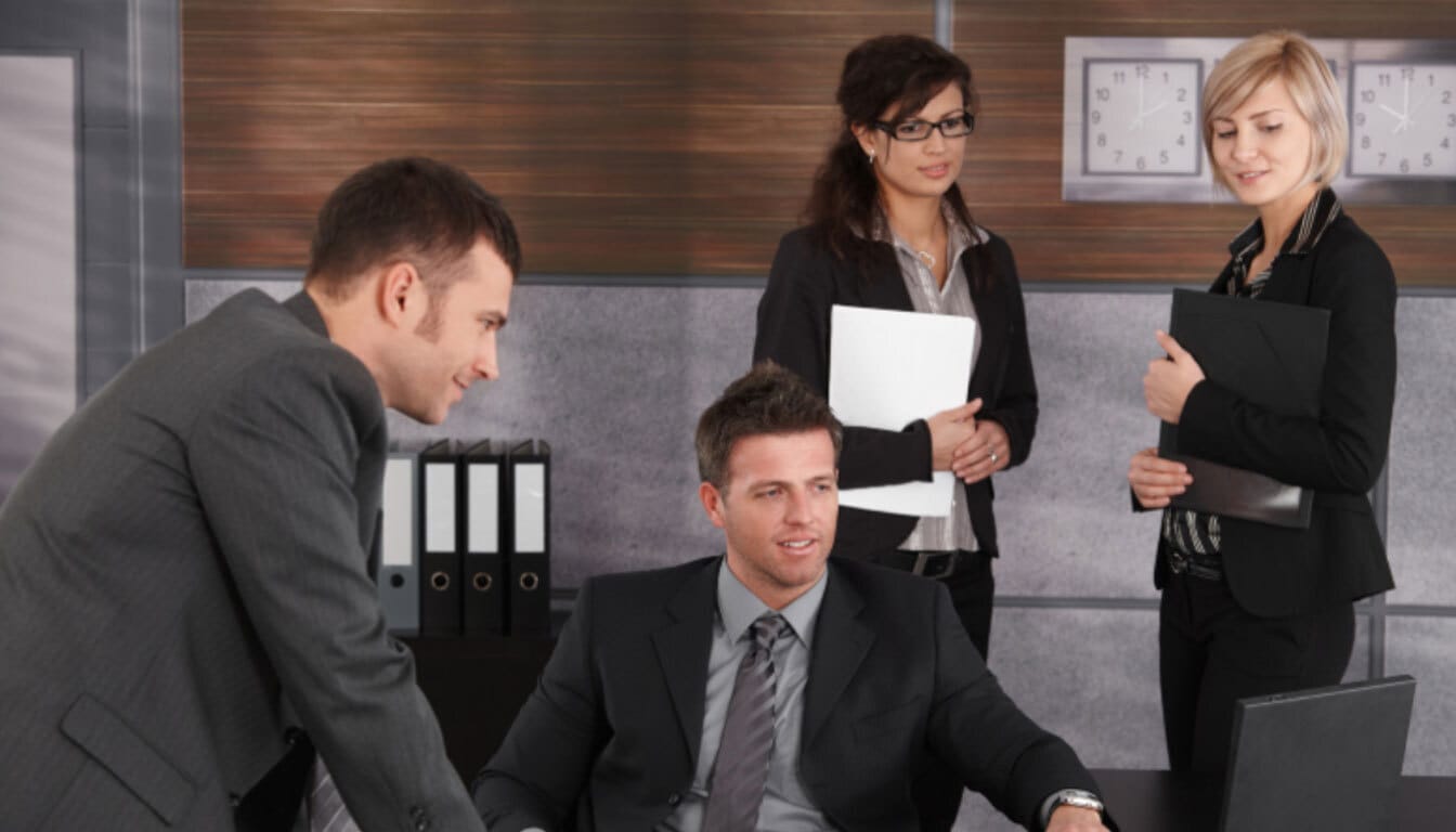 Sponsoring organisation representatives or UK immigration lawyers discussing a religious worker's application.