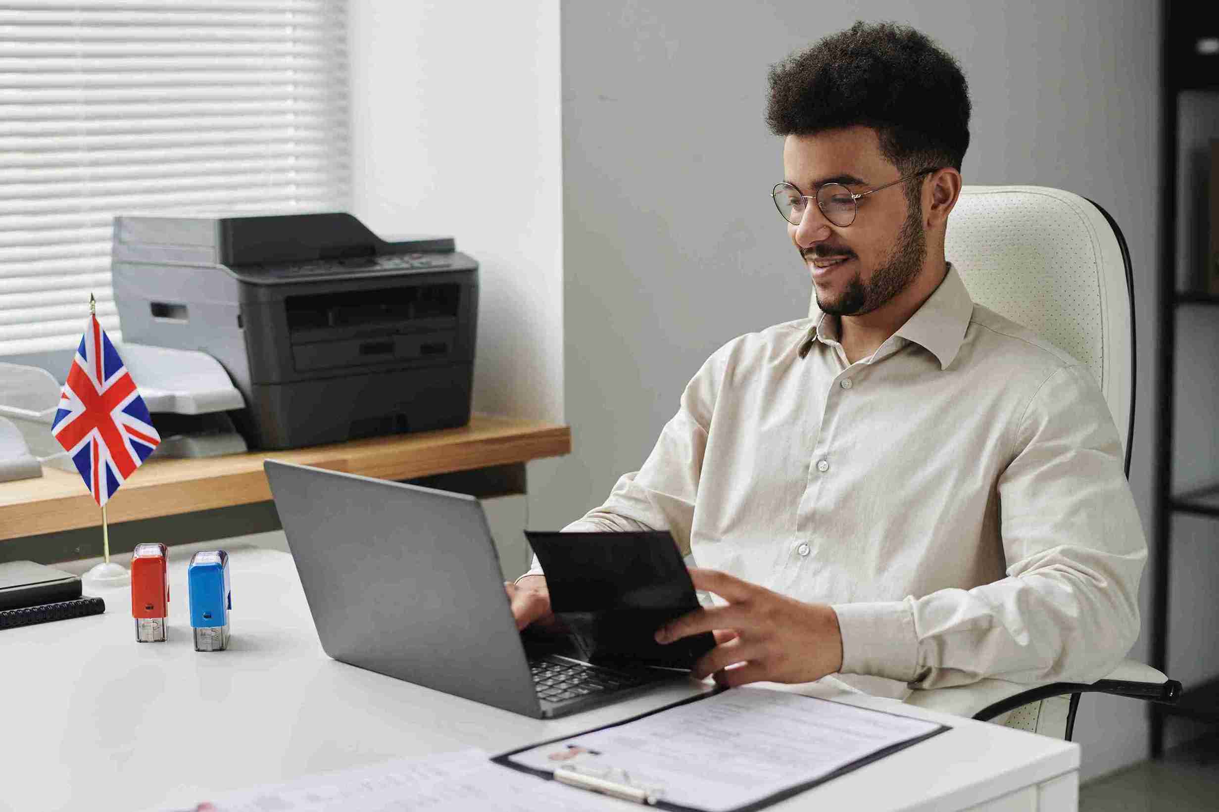 Man working at desk in bright modern office.