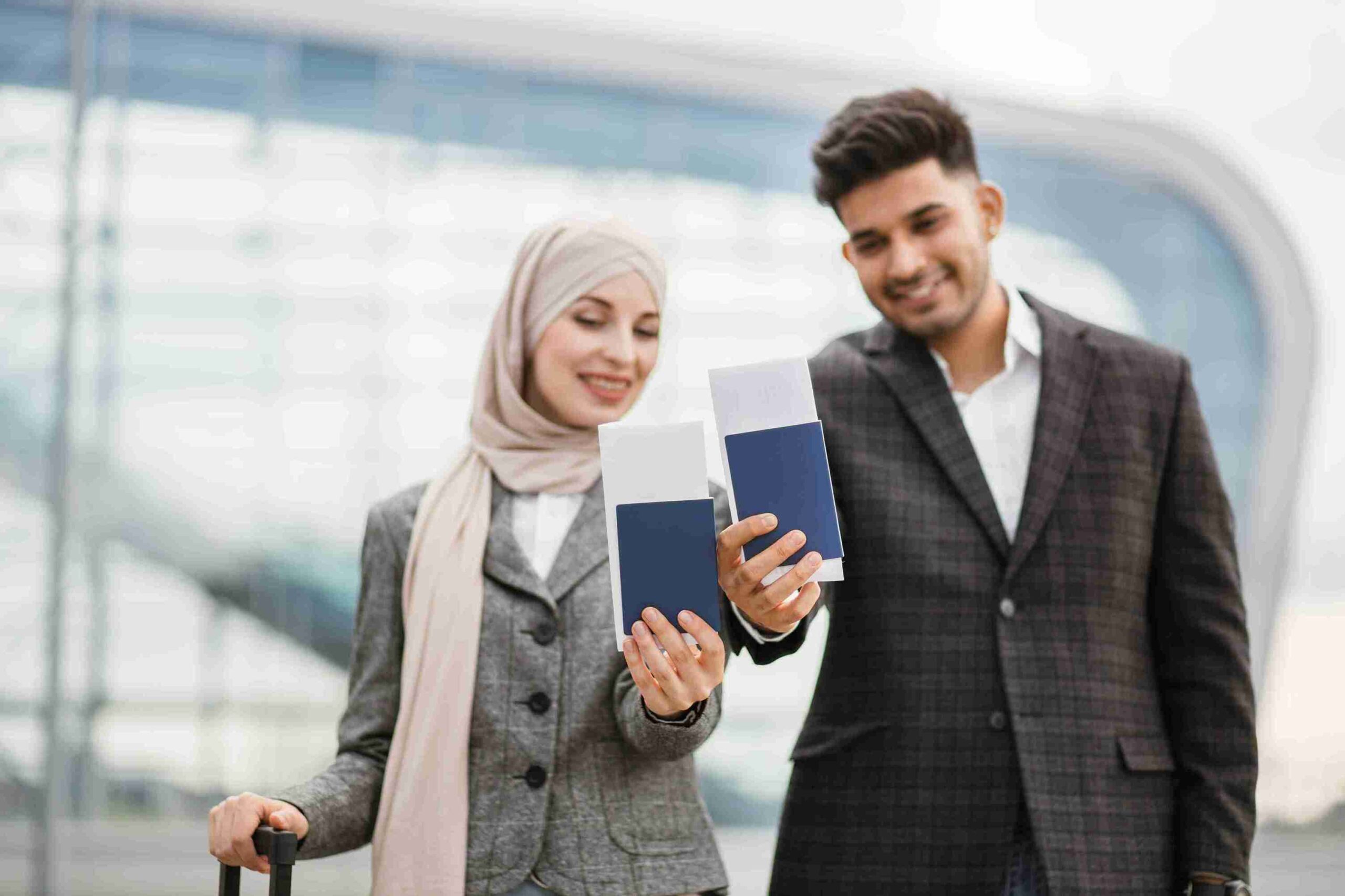 Two young graduate showing their passports with tickets illustrating student visa.