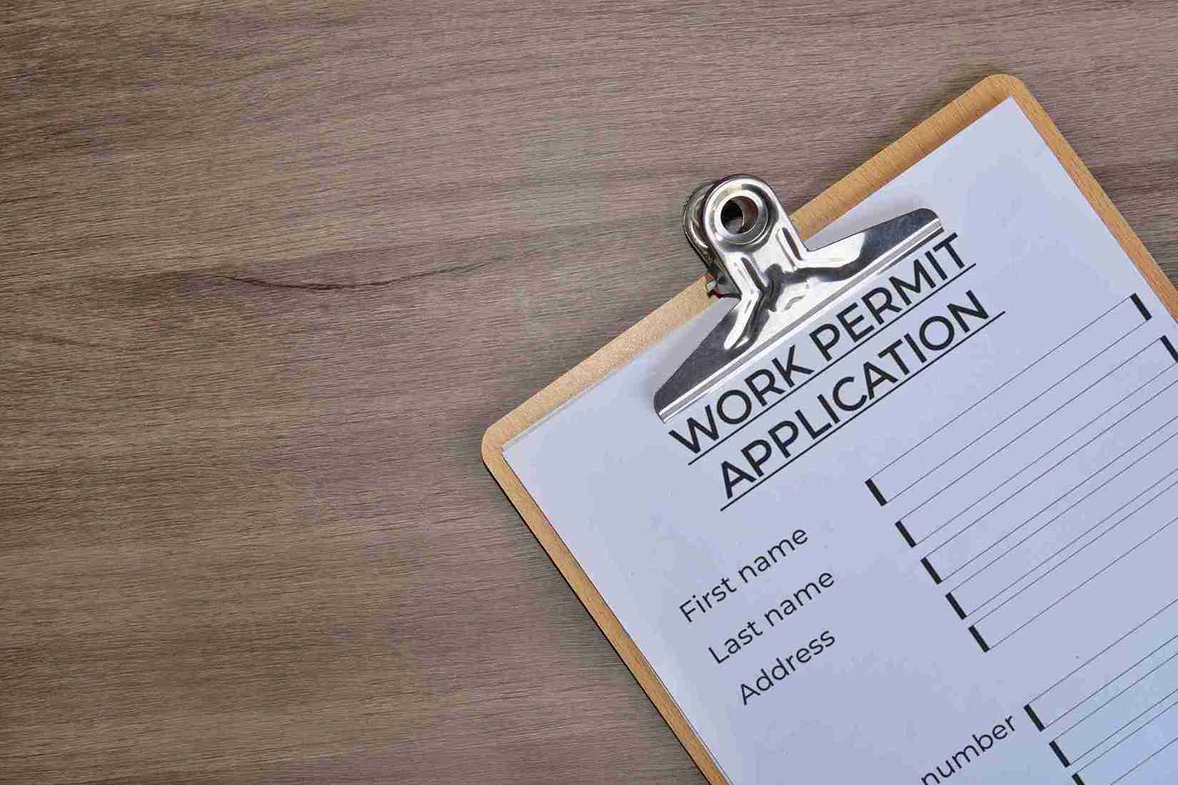 Top view of paper clipboard with work permit.